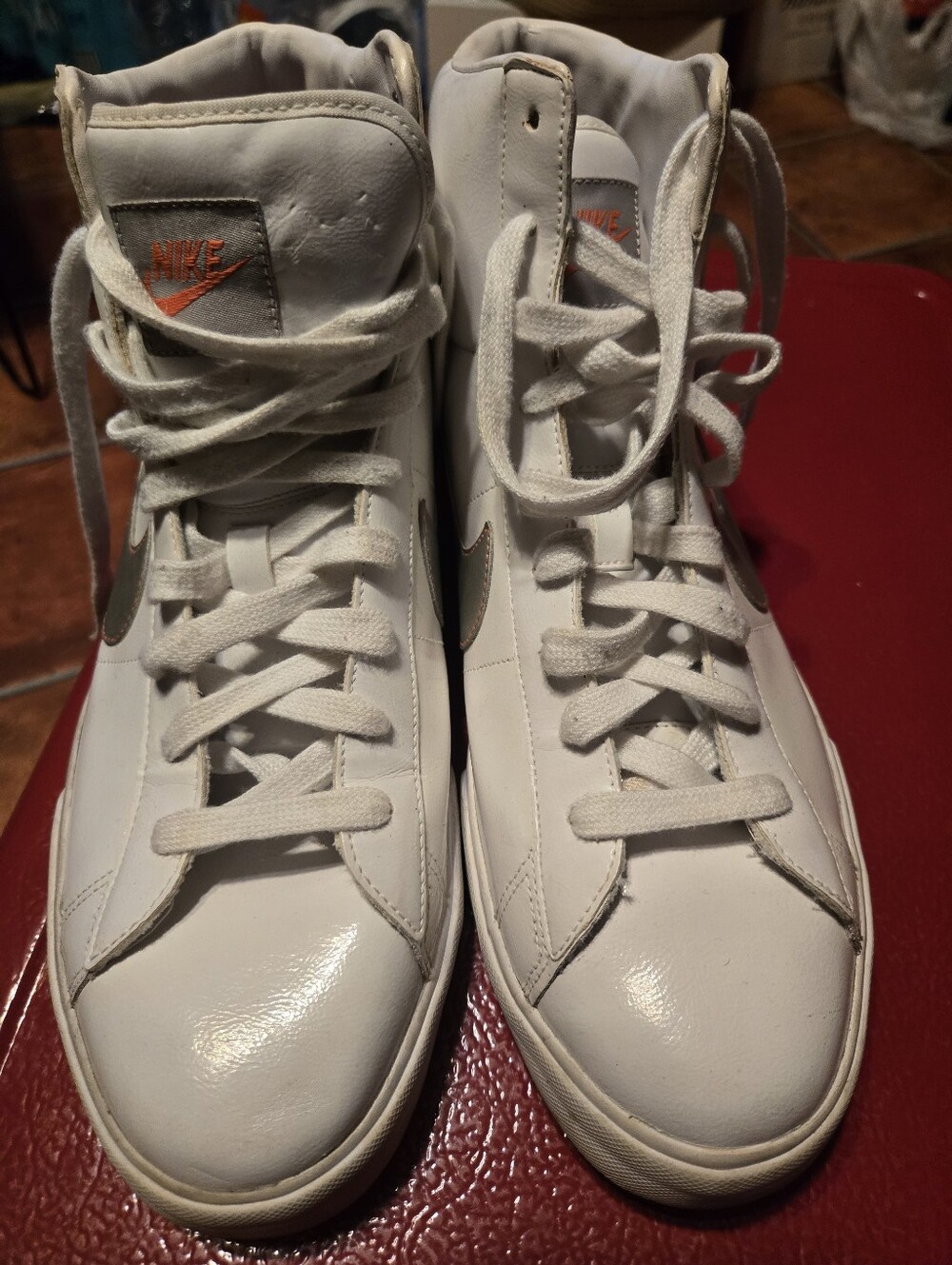 Nike White High-Top Sneakers with Orange Logo